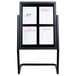A black metal Aarco double pedestal poster stand with white paper menus on it.