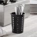 A black plastic Choice flatware holder with metal utensils inside.