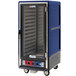 A blue Metro C5 heated holding and proofing cabinet with a clear door on a silver cart.