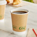 Two EcoChoice kraft paper hot cups filled with coffee on a table.
