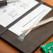 A green mint plastic wrapped round toothpick dispenser box on a table.