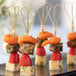 A table with a tray of Bamboo by EcoChoice heart skewers holding food and cheese.