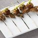 A plate of food with Bamboo by EcoChoice black bamboo skewers of meat and vegetables.