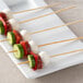 EcoChoice compostable bamboo skewers with meat and vegetables on a white plate.