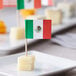 A Choice Mexican flag toothpick with cheese and crackers.