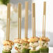 A plate of food on 6" bamboo double prong skewers.