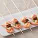 A plate of shrimp skewers with green peppers and mushrooms.