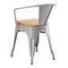 A Lancaster Table & Seating gray metal arm chair with a natural wood seat.