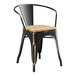 A black metal Lancaster Table & Seating restaurant chair with a natural wood seat.