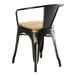 A black metal Lancaster Table & Seating chair with a natural wood seat.