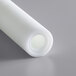 A roll of white plastic with a small hole in the center.