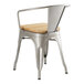 A Lancaster Table & Seating metal arm chair with a natural wood seat.