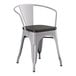 A Lancaster Table & Seating gray metal chair with black wood seat.