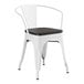 A white Lancaster Table & Seating metal arm chair with a black wood seat.