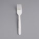 a white plastic fork on a gray background