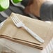 A white plastic fork from Preserve on a stack of napkins.