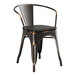 A black metal Lancaster Table & Seating arm chair with a black wood seat.