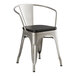 A Lancaster Table & Seating metal arm chair with black wood seat.