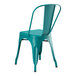 A teal metal Lancaster Table & Seating outdoor cafe chair with black legs.