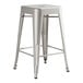 A silver metal backless counter height stool with legs.