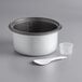 A white and grey Galaxy rice pot with a white spoon.