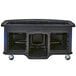 A black Cambro vending cart with blue wrap on a table.