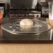 A ball of pizza dough on an American Metalcraft aluminum pizza pan.