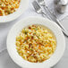 A white plate of Barilla gluten-free elbow pasta with a fork.