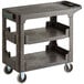 A black plastic Choice utility cart with three shelves and wheels.