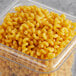 A plastic container of Barilla Cellentani pasta on a table.