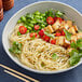 A bowl of Barilla Linguine Fini pasta with vegetables.