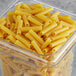 A white plastic container of Barilla Cut Ziti Pasta on a table.