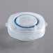 A clear plastic container with a blue lid.