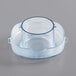 A clear plastic lid plug with a blue rim.