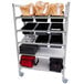 A white Cambro Camshelving Premium Flex Station with plastic trays and bags on shelves.