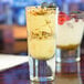 A Libbey Troyano shooter glass filled with dessert with blueberries and granola.