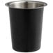 A matte black metal cylinder with silver flatware inside.