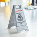 A Lavex gray caution wet floor sign.