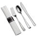 White plastic dinnerware with silver flatware and a white napkin.