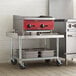 A galvanized steel leg for a kitchen equipment stand on a kitchen counter.
