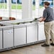 An Avantco stainless steel refrigerated salad bar on a counter.