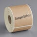 A roll of brown Kraft paper labels with black text that reads "TamperSafe" and "2 1/2" x 6" - 250/Roll"