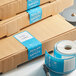 A stack of boxes with blue TamperSafe labels on them.