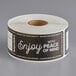 A roll of black paper TamperSafe labels with white text reading "Enjoy With Peace Of Mind"