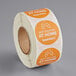 A roll of white and orange TamperSafe Best Enjoyed At Home drink labels.