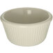 A Carlisle bone white fluted melamine ramekin with a ruffled edge.