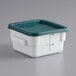 A white and green container with a green lid.