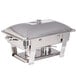 A silver stainless steel Vollrath Orion rectangular chafer with a lid on a table.