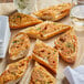 A plate of toasted bread with green sprinkles on it.