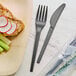 A plate of food with a EcoChoice compostable fork and knife.